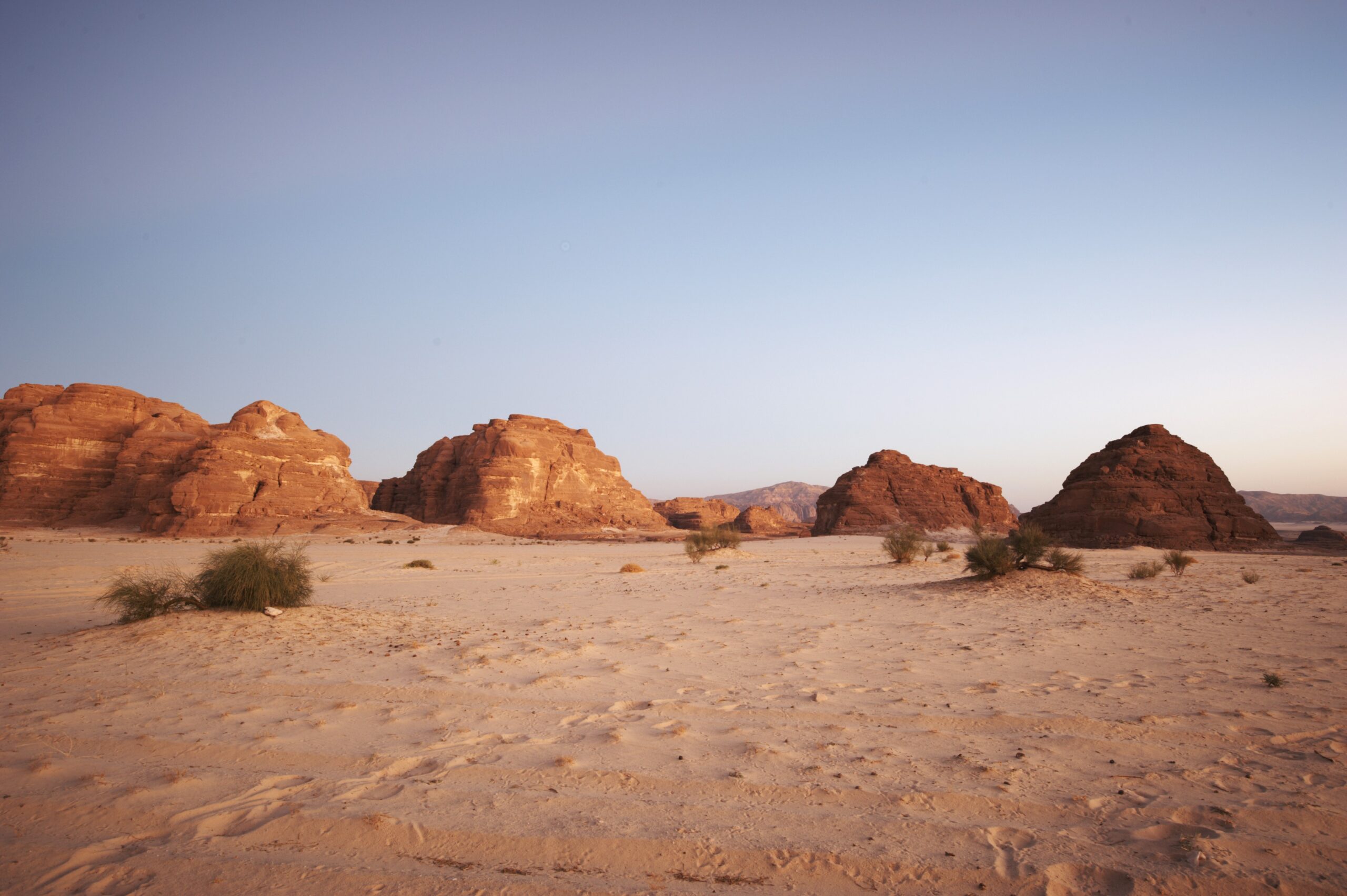 Valley in the Sinai desert with mountains and sun.